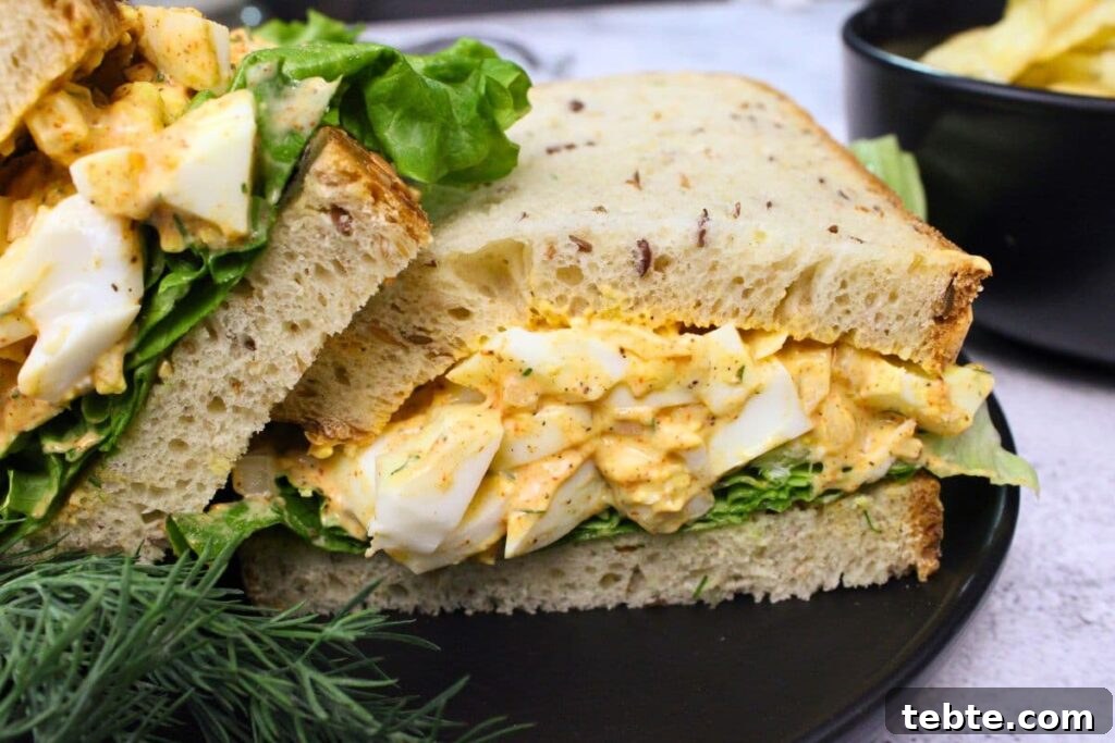 closeup view of air fryer egg salad sandwich on a black plate