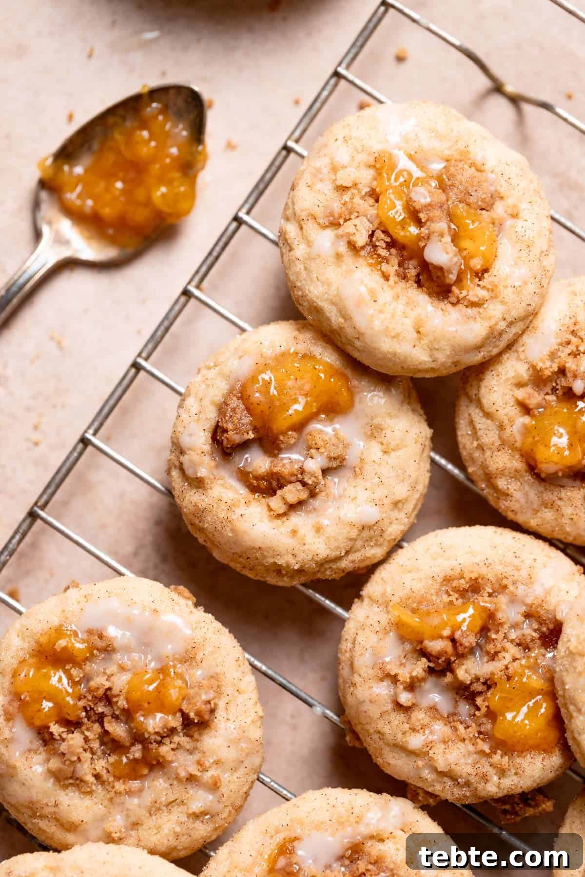 peach cobbler cookies with peach jam and vanilla glaze on top.