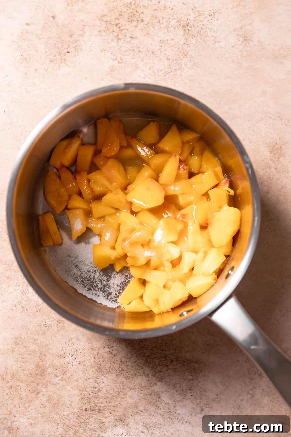 fresh peaches cooking in a pot.