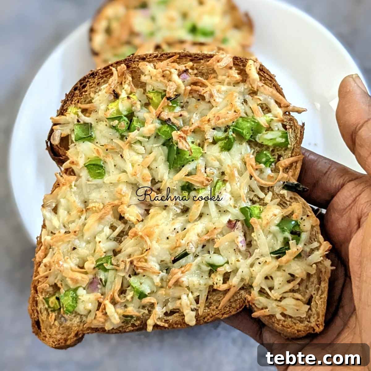 Spicy Chilli Cheese Toast Recipe for Quick Savory Snacks 2 One chilli toast being held up in hand