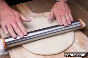 Crispy Garlic Pizza Bread Recipe — Cheesy Garlic Pull-Apart Loaf 11 Rolling out the pizza bread dough flat with a rolling pin