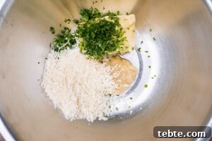 Crispy Garlic Pizza Bread Recipe — Cheesy Garlic Pull-Apart Loaf 13 Garlic, butter, parmesan and chopped parsley in a mixing bowl