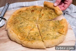 Crispy Garlic Pizza Bread Recipe — Cheesy Garlic Pull-Apart Loaf 16 Picking up a slice of Garlic Pizza Bread