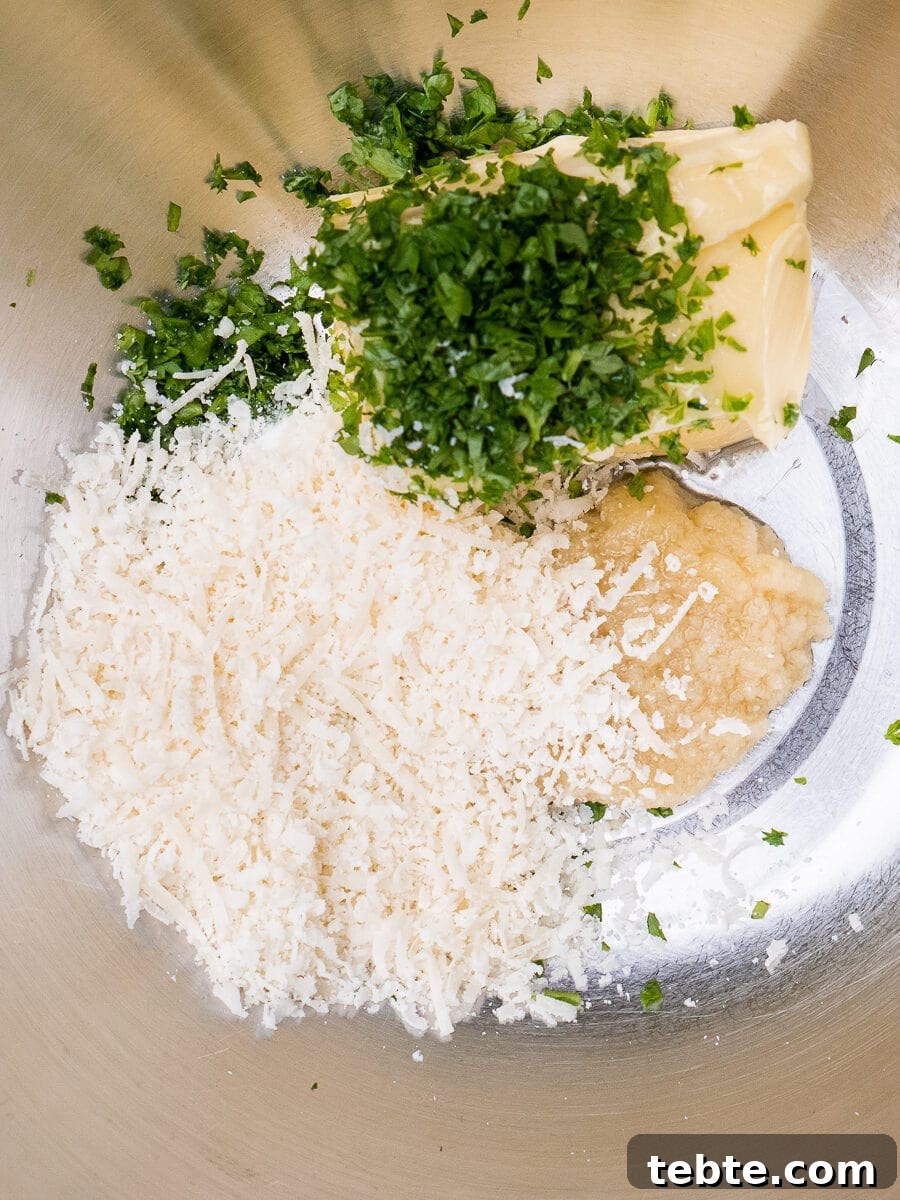 Crispy Garlic Pizza Bread Recipe — Cheesy Garlic Pull-Apart Loaf 21 Garlic, butter, parmesan and chopped parsley in a mixing bowl