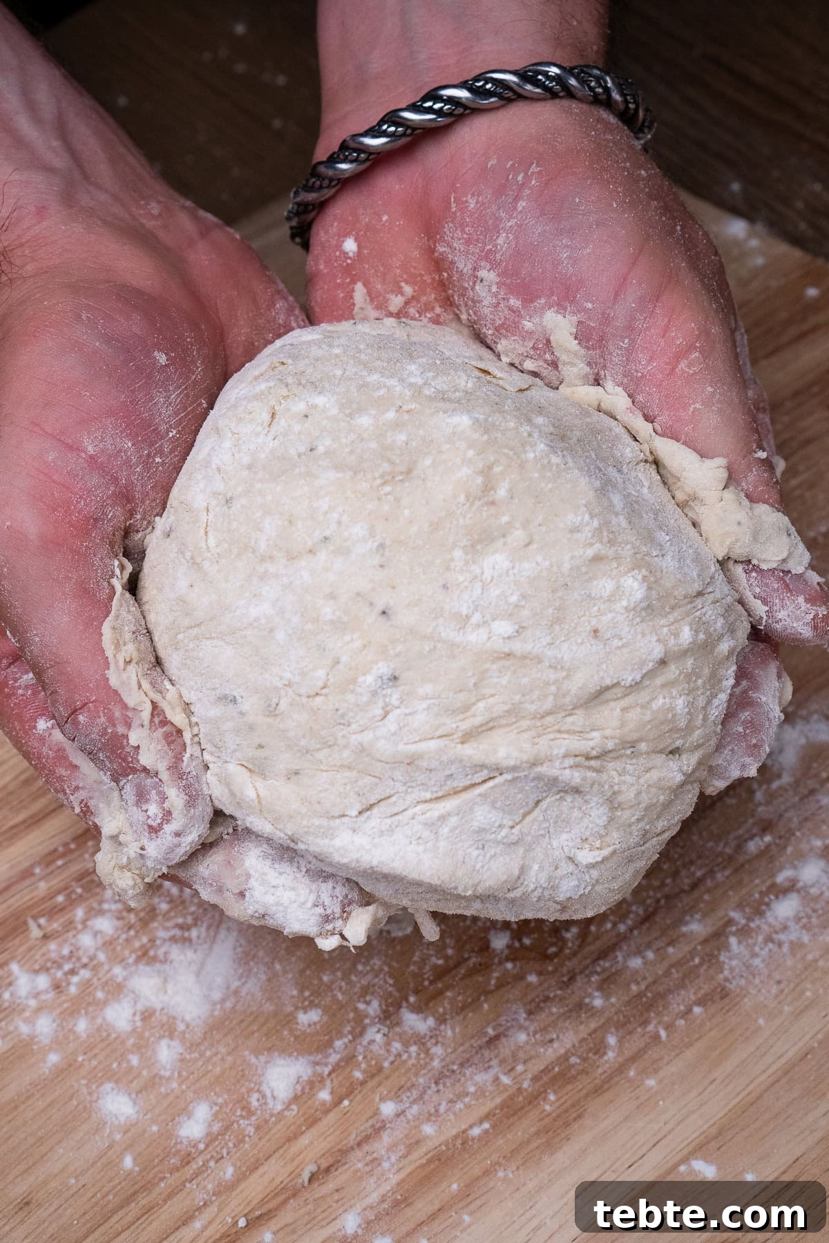 Crispy Garlic Pizza Bread Recipe — Cheesy Garlic Pull-Apart Loaf 25 Pizza Bread dough in hands