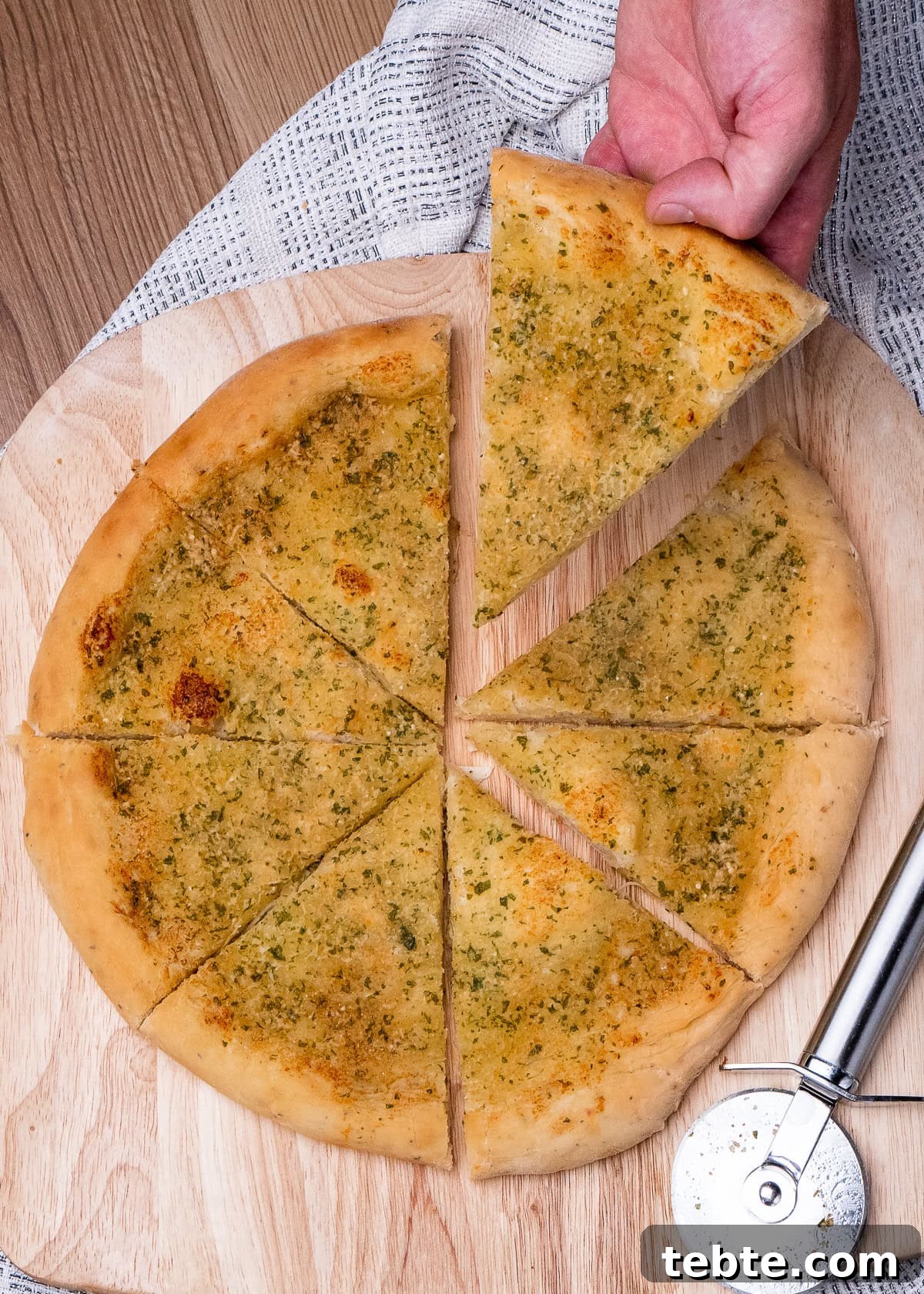 Crispy Garlic Pizza Bread Recipe — Cheesy Garlic Pull-Apart Loaf 34 Holding a slice of Garlic Pizza Bread