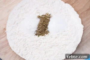 Crispy Garlic Pizza Bread Recipe — Cheesy Garlic Pull-Apart Loaf 6 Plain flour, dried mixed herbs, salt and sugar in a mixing bowl