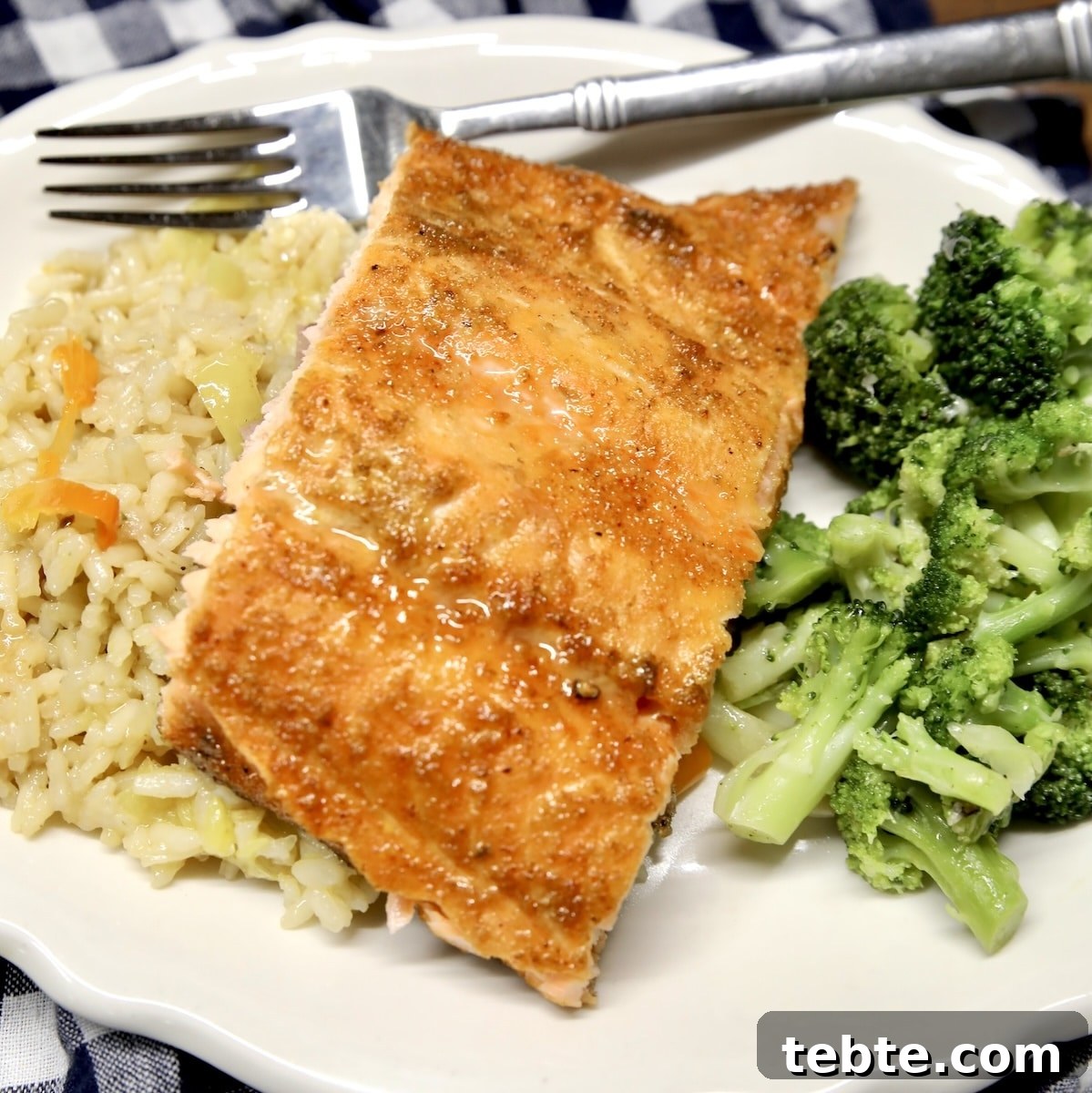 Orange Glazed Salmon Recipe with Citrus Soy Glaze 11 Spicy maple glazed salmon fillet on a plate with rice and broccoli.