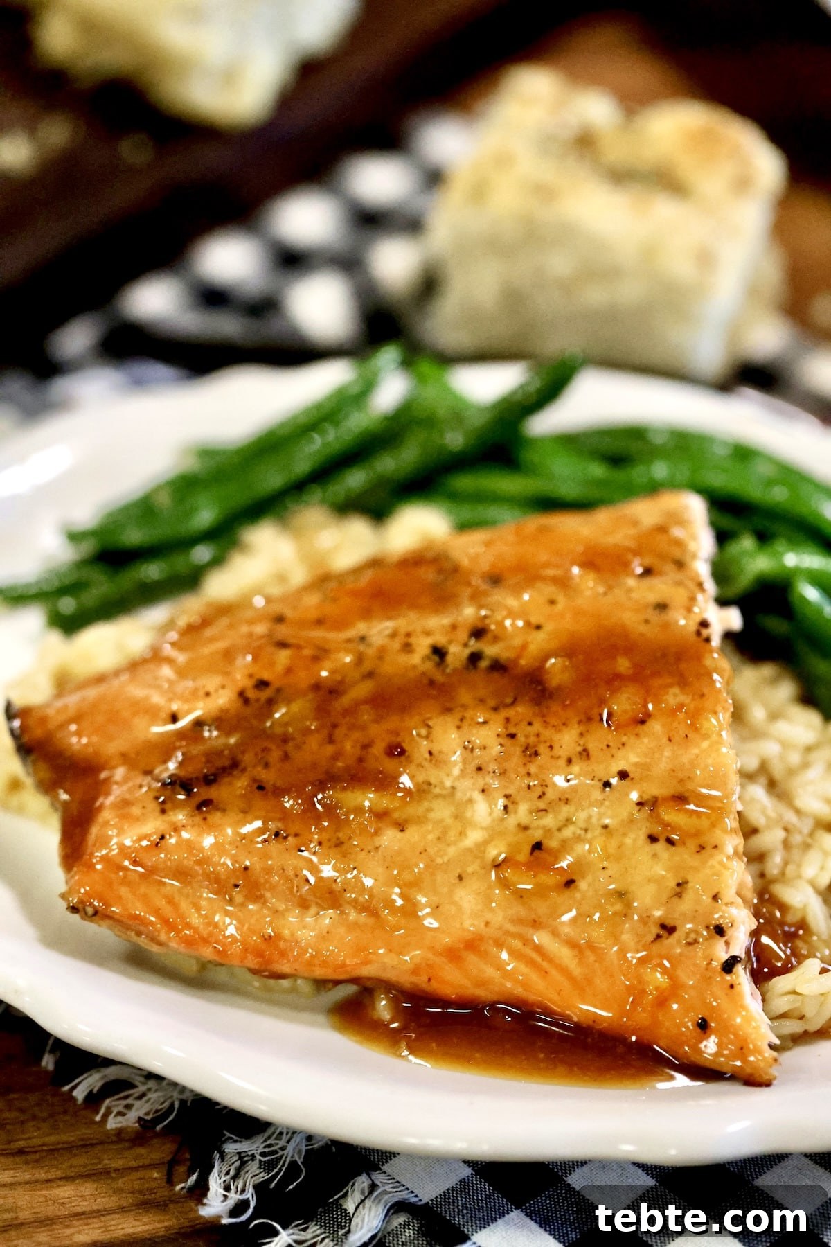 Orange Glazed Salmon Recipe with Citrus Soy Glaze 15 Grilled orange salmon on a plate with rice and green beans.