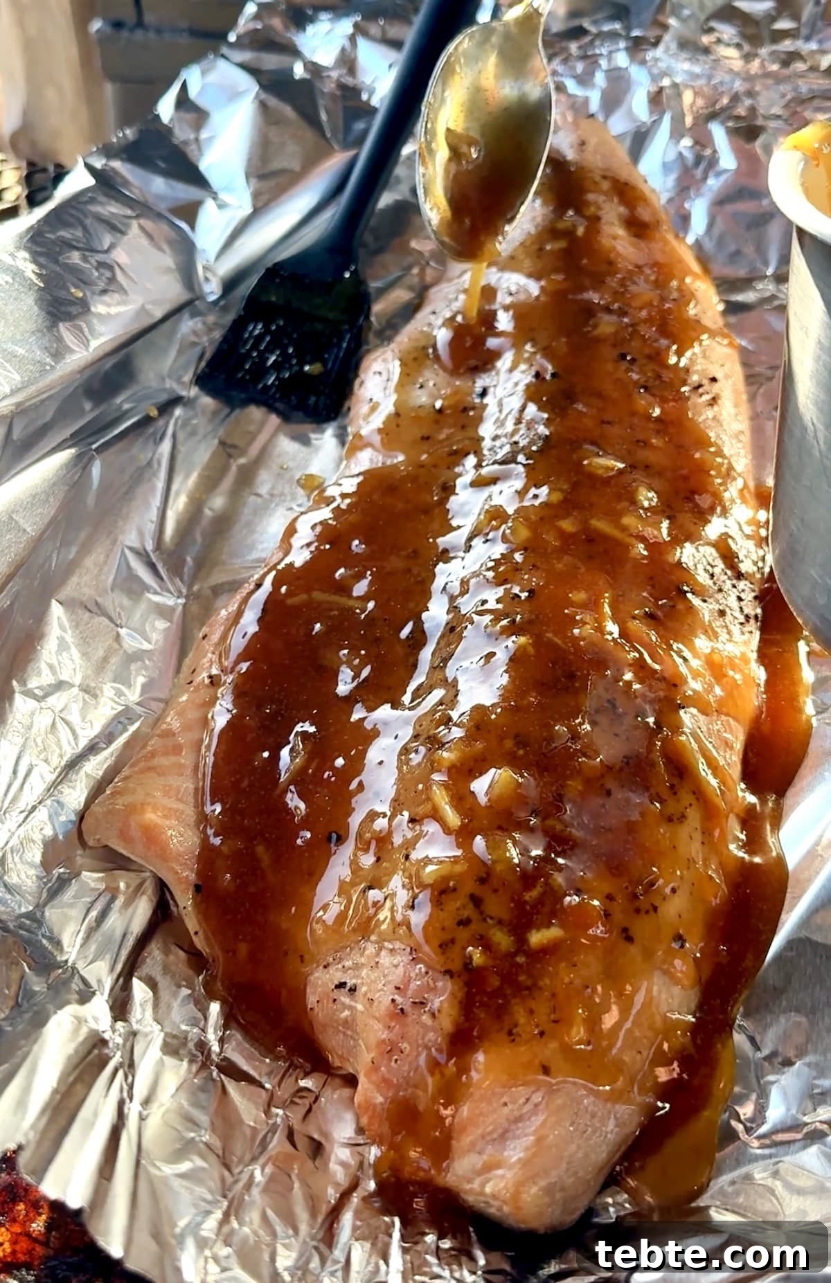 Orange Glazed Salmon Recipe with Citrus Soy Glaze 6 Orange glazed salmon on aluminum foil.
