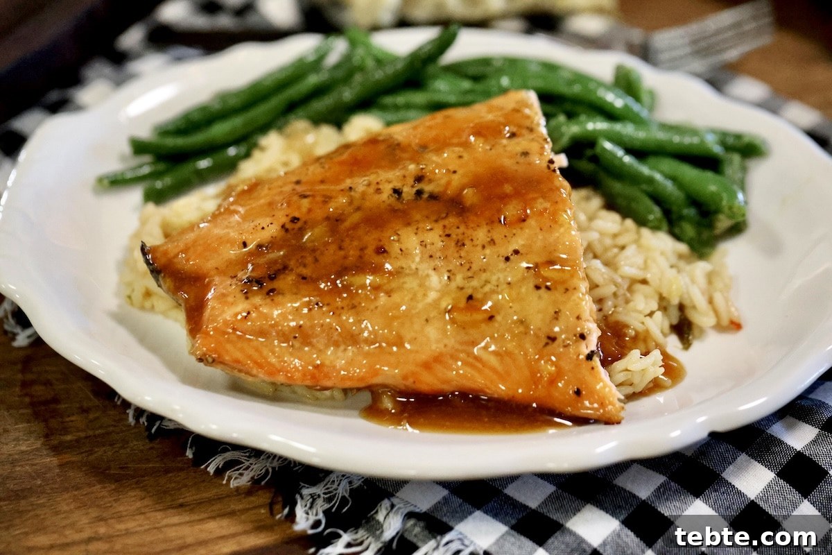Orange Glazed Salmon Recipe with Citrus Soy Glaze 9 Plate of salmon, rice and green beans.