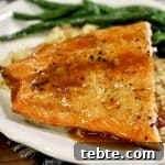 Orange Glazed Salmon Recipe with Citrus Soy Glaze 10 Salmon with orange glaze on a plate with rice and green beans.