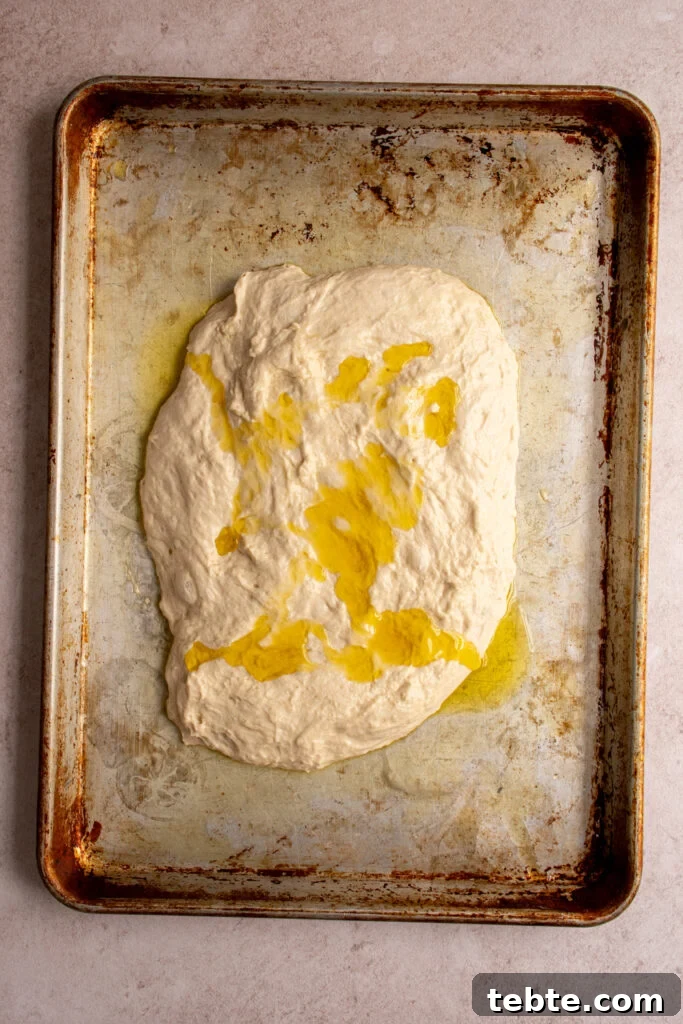 Authentic Italian Focaccia Bread Recipe 8 Olive oil drizzled over the top of the focaccia dough.
