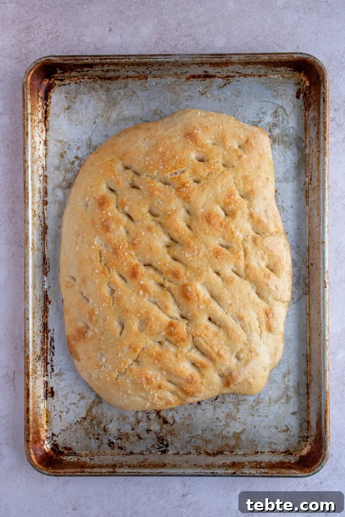 Authentic Italian Focaccia Bread Recipe 9 Freshly baked focaccia bread on a sheet pan.