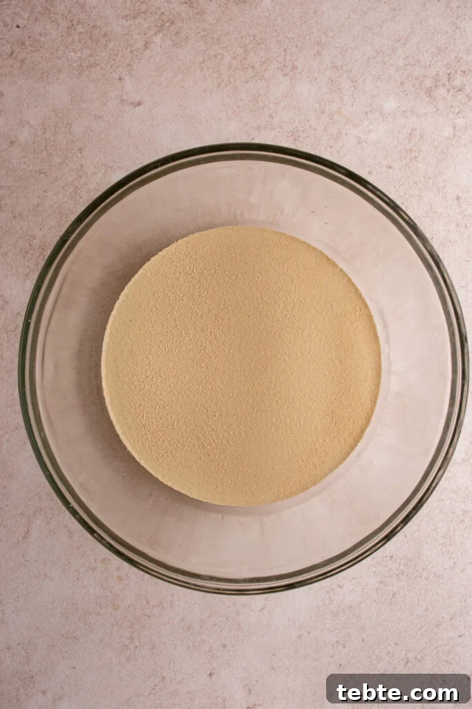 Authentic Italian Focaccia Bread Recipe 5 Adding yeast and warm water together for focaccia dough.