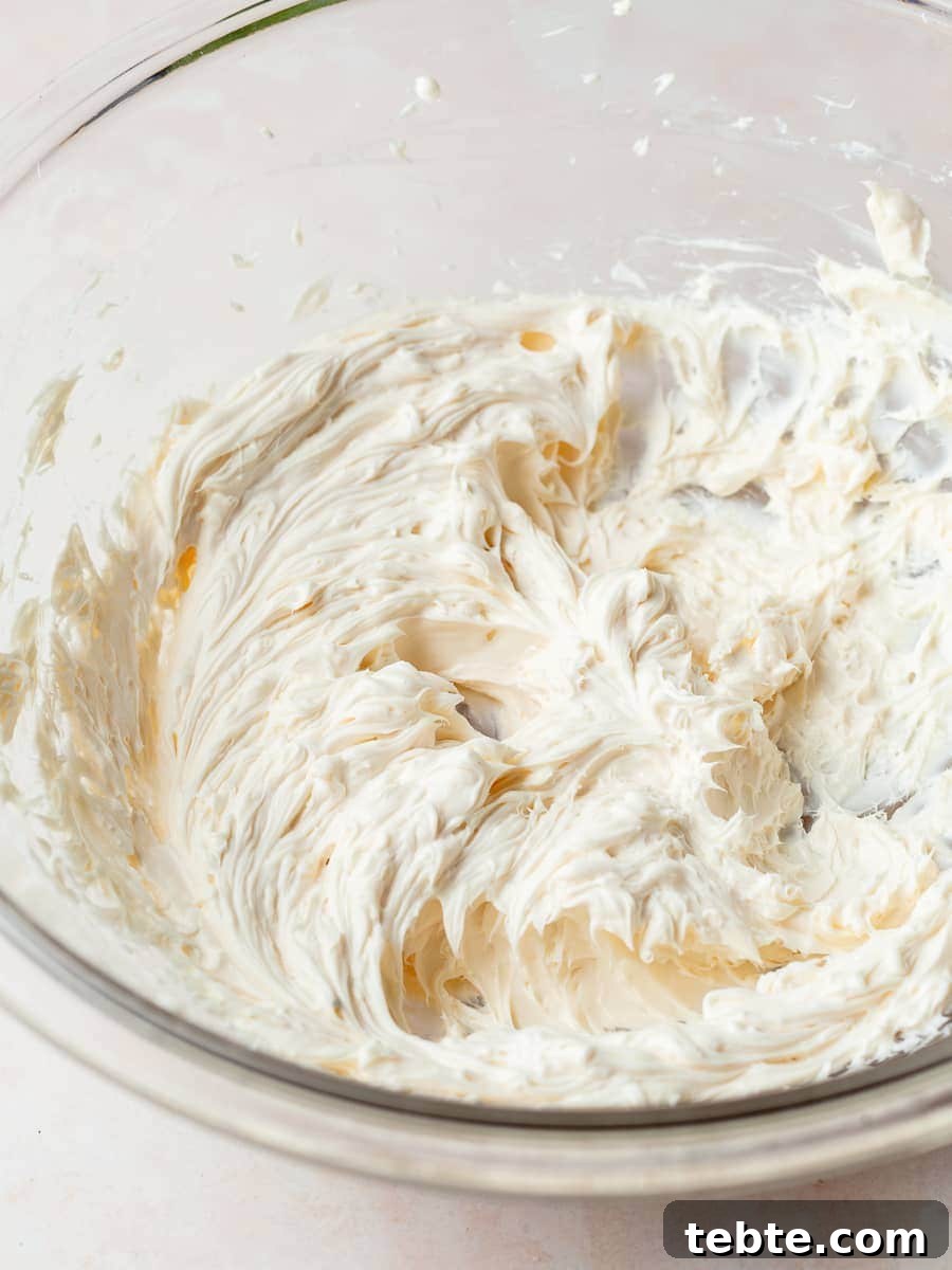 a bowl of cream cheese filling for pumpkin cheesecake muffins