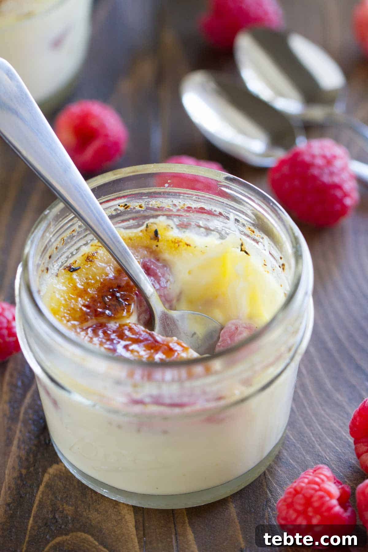 Raspberry Creme Brûlée with a bite taken from it.