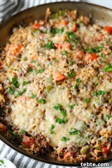 Deconstructed stuffed peppers in skillet.