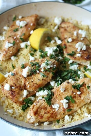 Chicken couscous in skillet with lemon, feta, and parsley.