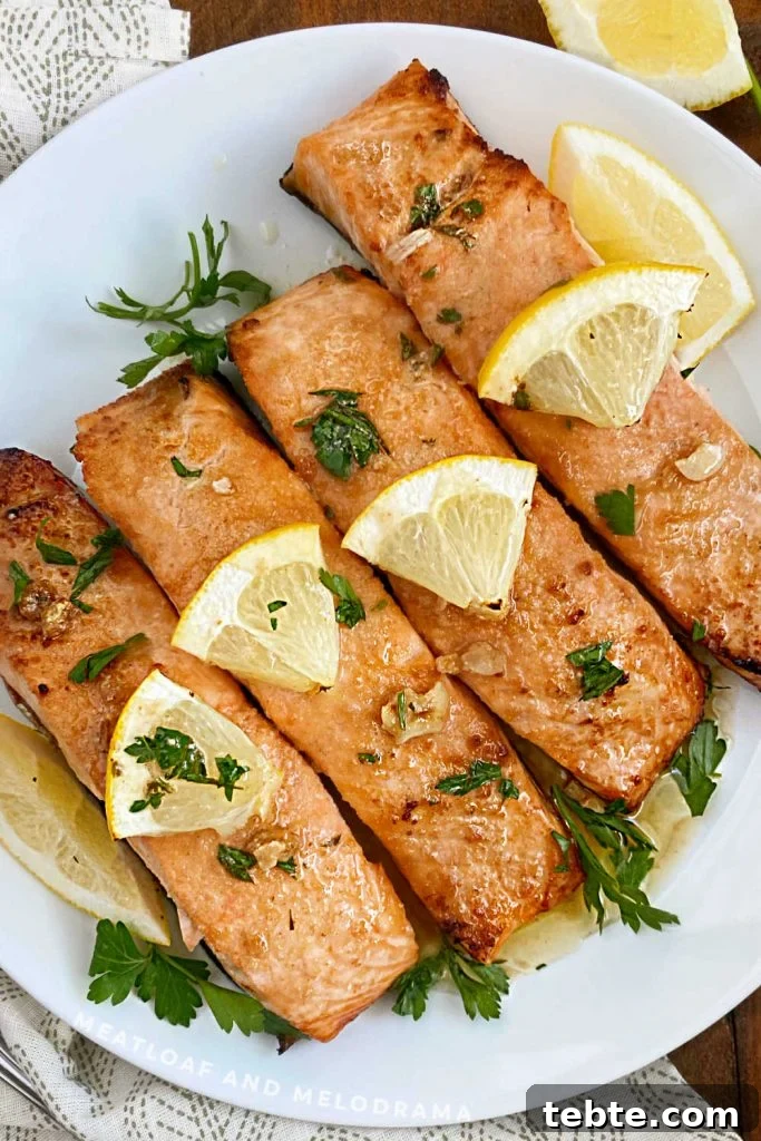 plate of lemon garlic butter salmon with lemon slices