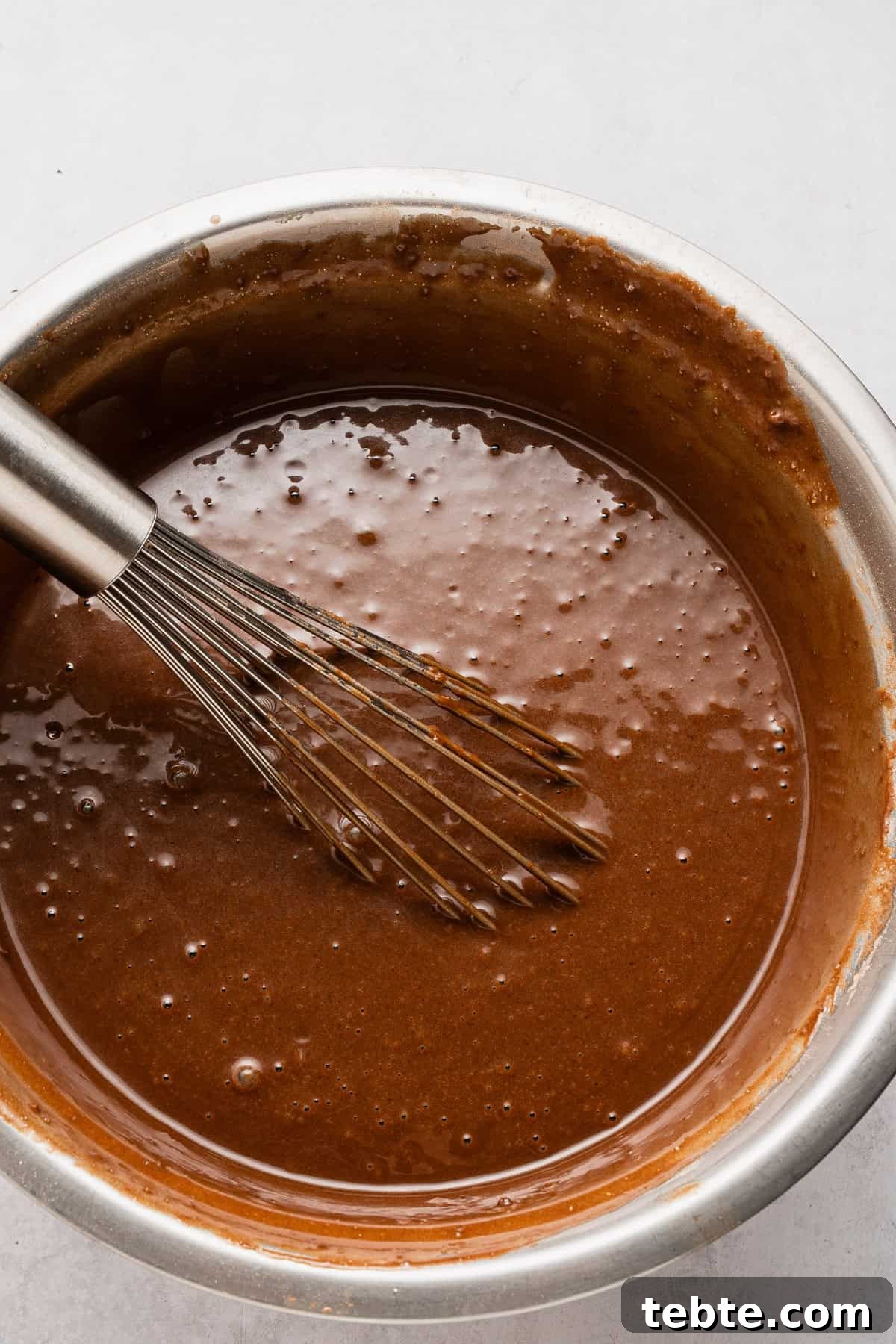Decadent Chocolate Tres Leches Cake Recipe 5 Adding wet ingredients to dry ingredients.