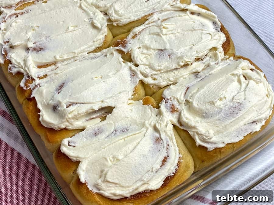 Classic Old-Fashioned Cinnamon Rolls Recipe for Soft, Gooey Buns 7 Messy frosting slathered across cinnamon rolls in a pan