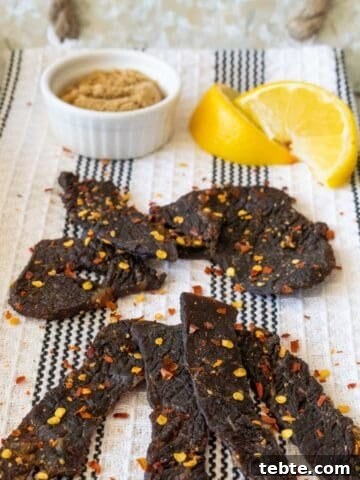 beef jerky on tray with lemons and spices