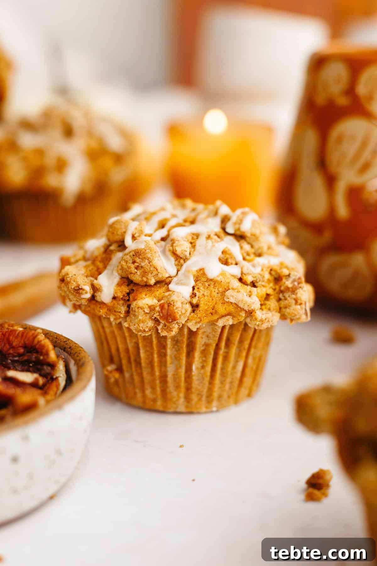 Pumpkin Pecan Muffins with Crunchy Pecan Streusel 2 A close up of a pumpkin pecan muffin with a pecan streusel.