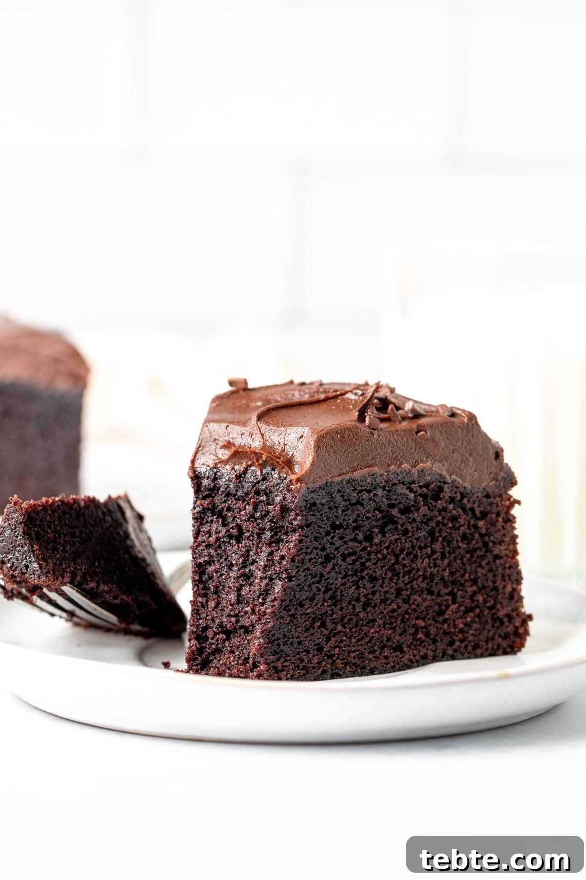 Decadent Mini Chocolate Cake Recipe for Two 7 Slice of a mini chocolate cake on a plate with a bite taken out.
