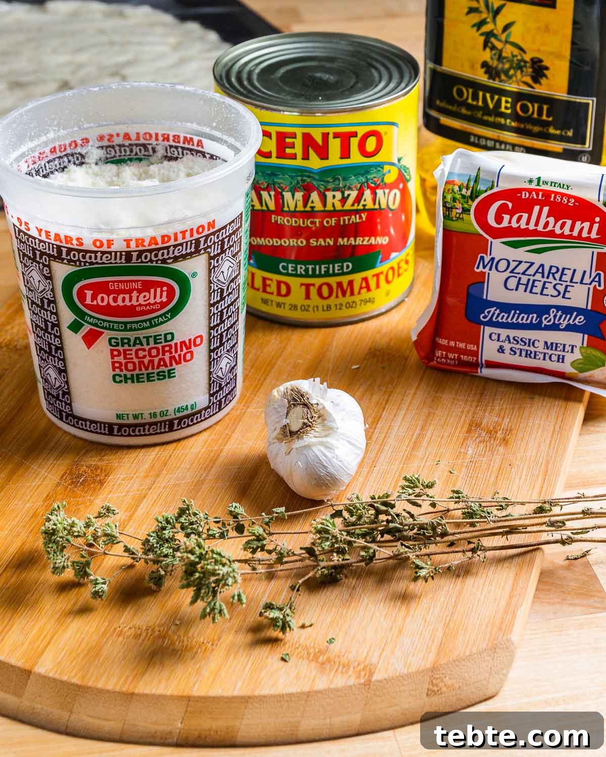 Steak Pizzaiola Recipe: Flavorful Affordable Weeknight Steak Dinner 7 Ingredients shown: Locatelli Pecorino Romano, San Marzano tomatoes, mozzarella cheese, olive oil, garlic, and Sicilian oregano.