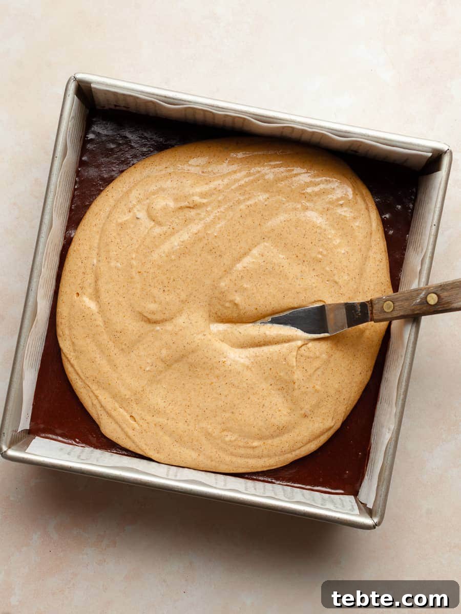 Gluten-Free Pumpkin Cheesecake Brownies Recipe for Fall Baking 16 gluten free brownie batter topped with gluten free pumpkin cheesecake batter for pumpkin cheesecake brownies