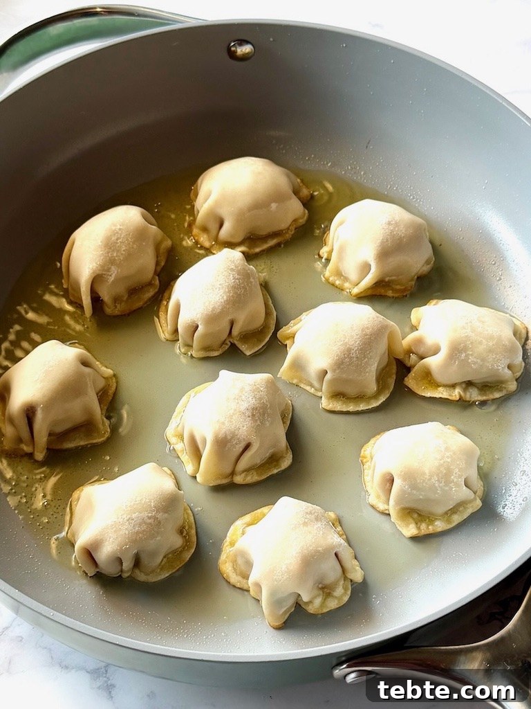 No-Fold Chicken Dumplings Recipe: Quick Homemade Potstickers 9 Chicken dumplings frying in a non-stick skillet.