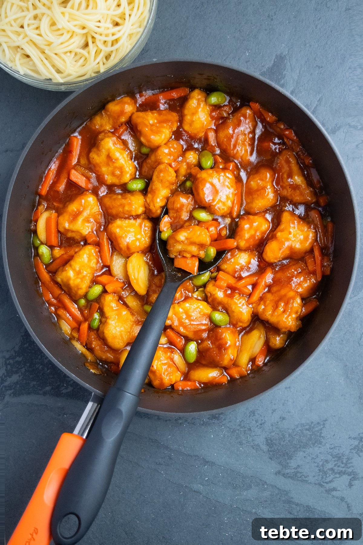 Easy homemade Chinese sweet and sour chicken in nonstick pan- Overhead shot. 