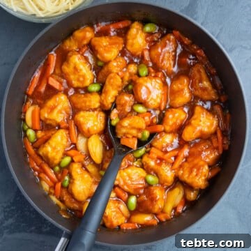 Overhead shot of best easy homemade Chinese sweet and sour chicken in nonstick pot- Overhead shot.