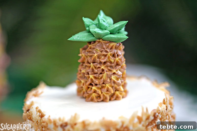 Close-up of buttercream pineapple on top of pineapple cupcakes | From SugarHero.com