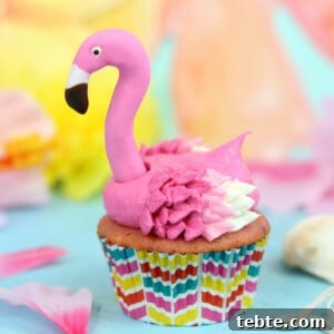 Close up of a Flamingo Cupcake on a blue surface.