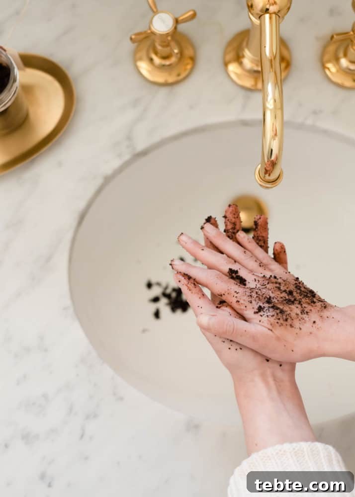 Coconut Coffee Scrub DIY: Glow-Boosting Body & Face Exfoliant 3 Woman using DIY coconut coffee scrub on hands over marble sink with brass faucet.