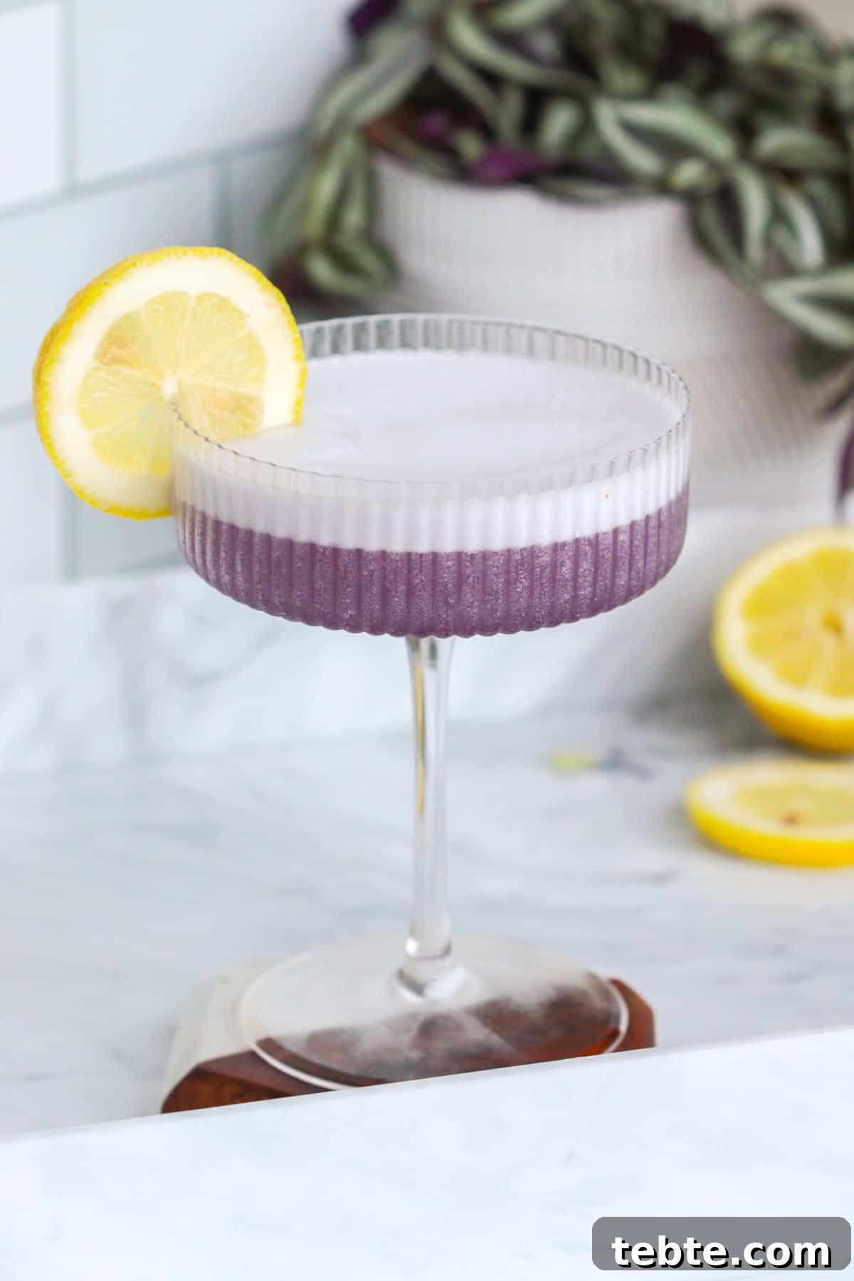 12 Crème de Violette Cocktails to Try Tonight 5 Violet lady cocktail with creme de violette and lemon wheel.