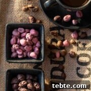 Homemade Chocolate-Covered Coffee Beans Recipe for Snacking 3 Ruby and dark chocolate covered coffee beans in black pots, on a coffee sack background.