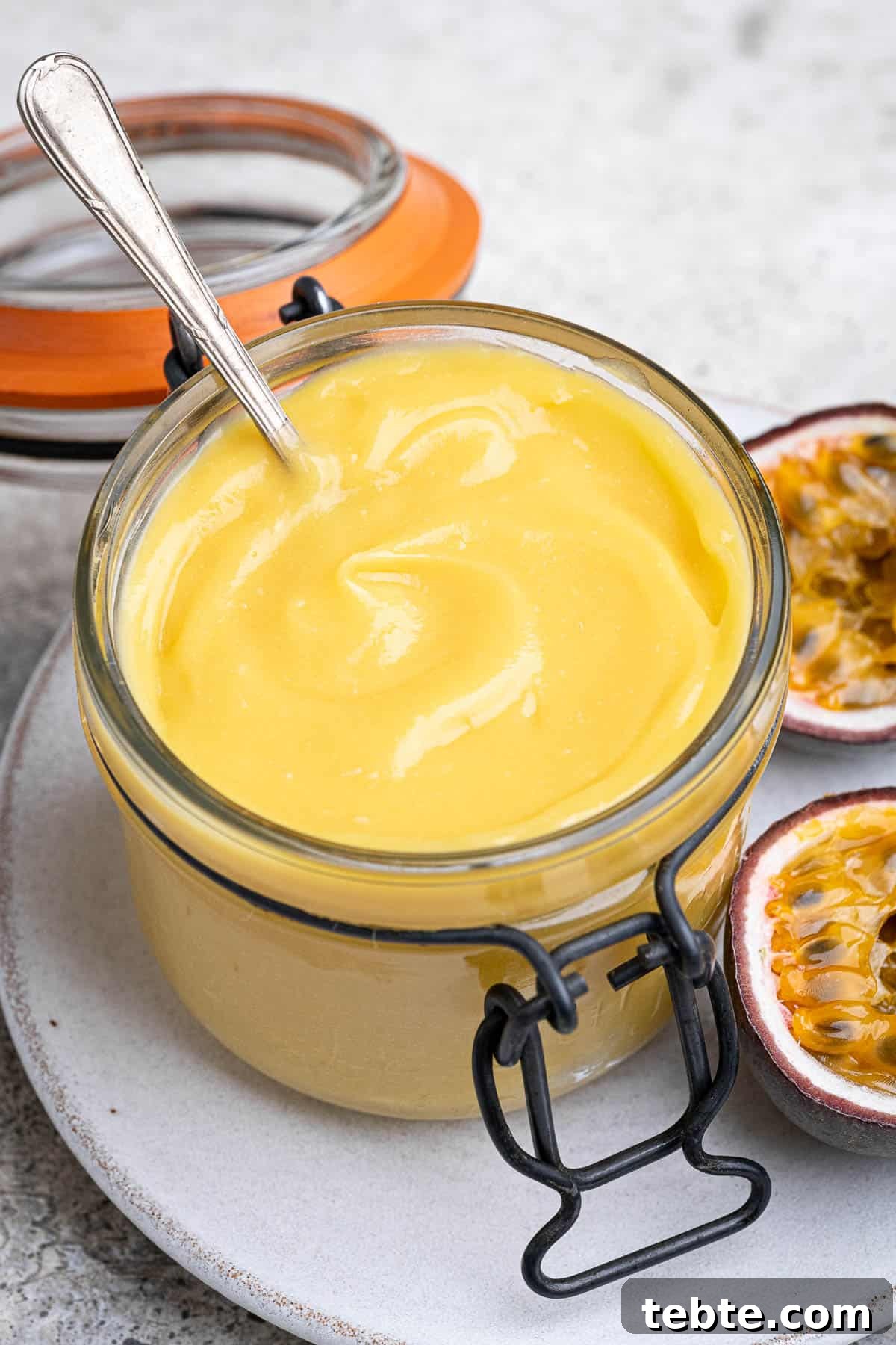 Vibrant Vegan Passion Fruit Curd Recipe for Tarts & Toast 4 Close up of a jar of vegan passion fruit curd.