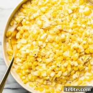 Creamy Southern-Style Creamed Corn Recipe 7 a bowl of creamed corn with a spoon