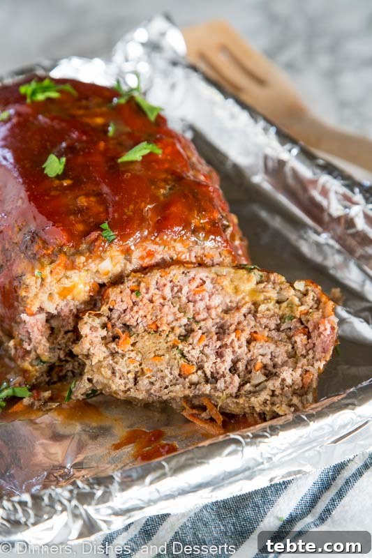 Classic Comfort Meatloaf Recipe with Savory Glaze 3 A close up of a piece of cake on a paper plate, with Meatloaf and Dinner