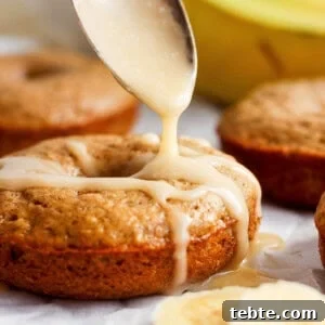 Drizzling icing onto freshly baked banana muffins.