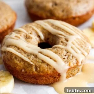 A banana-flavored donut with a glaze topping on a white background.
