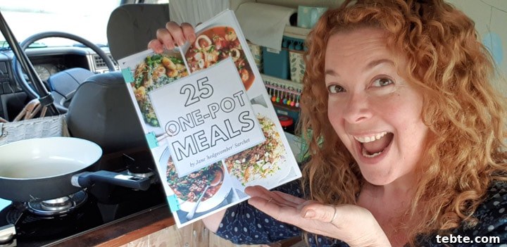 One-Pot Meals Cookbook: 50 Quick, Flavorful Recipes for Busy Weeknights 5 person holding printed A4 eBook in campervan kitchen
