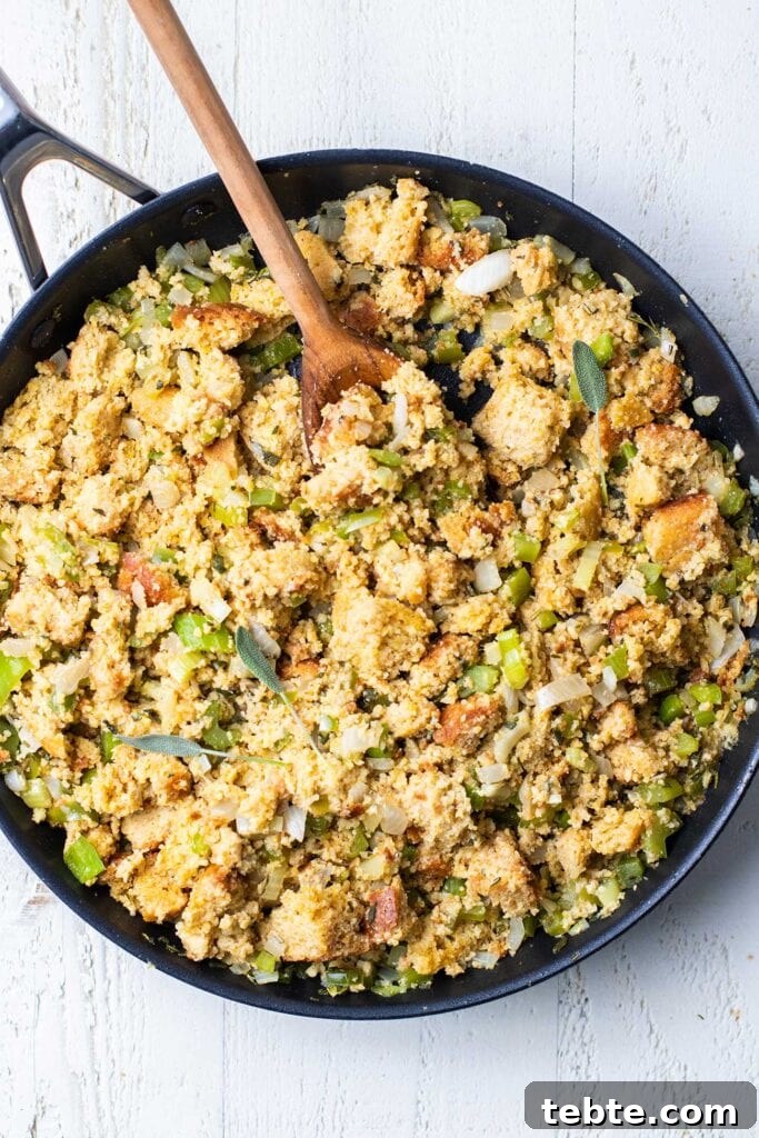 Southern Cornbread Dressing Recipe for Holiday Tables 6 Cornbread dressing in a skillet, ready to be stuffed in a turkey or chicken.