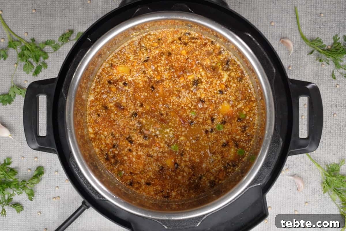 Jowar Khichdi Recipe: Wholesome Millet One-Pot Meal 10 Water, jowar powder and added to the pot.