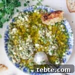 Jalapeno popper bread dipping oil on a blue and white patterned plate.