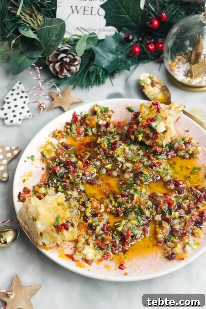 Jalapeño Popper Bread with Creamy Dipping Oil Recipe 7 Festive dipping oil in a small pink plate on a grey surface.