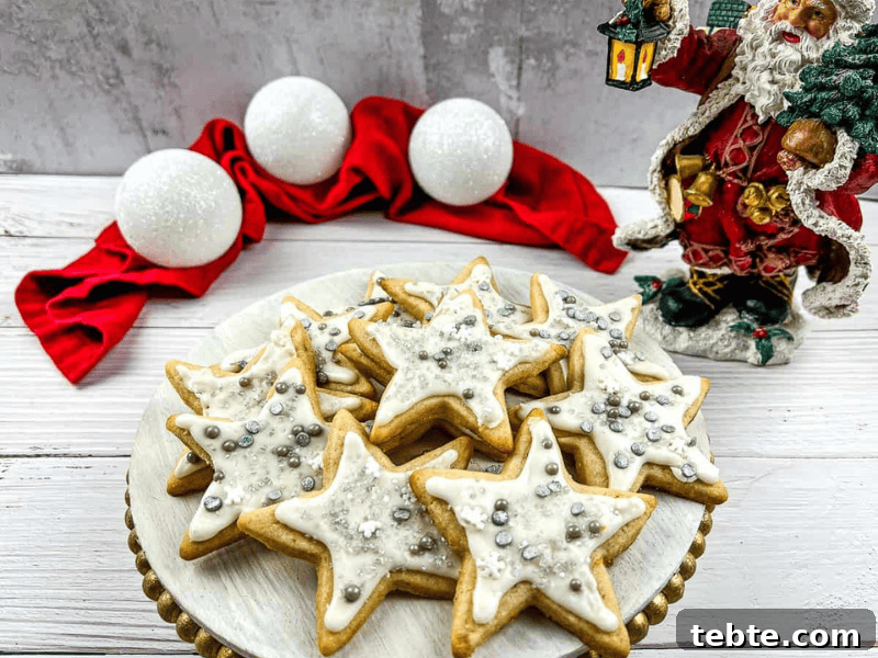 13 Christmas Cookies That Win Every Office Cookie Exchange 9 Eggnog sugar cookies on a plate with santa claus figurines.